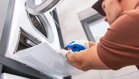 Dryer technician repairing a laundry appliance in Philadelphia PA