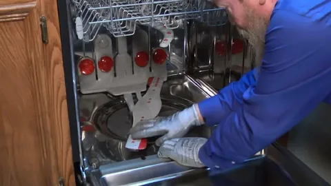 Emergency dishwasher repair technician fixing a built-in dishwasher in Philadelphia PA