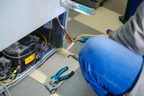 Home refrigerator repair technician servicing a fridge in Philadelphia PA