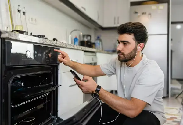 Licensed appliance technician repairing an oven in Philadelphia PA