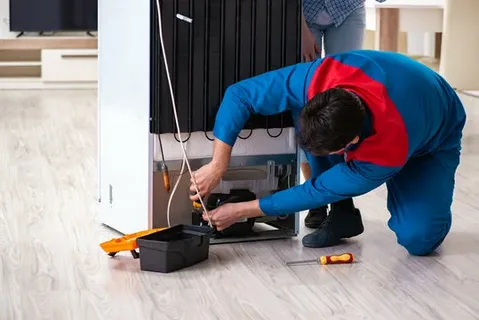 Refrigerator repair technician servicing a fridge in Philadelphia PA