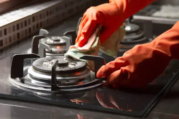 Gas stove burner repair technician fixing a cooktop in Philadelphia PA