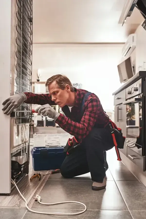 Appliance repair technician servicing a home appliance in Philadelphia PA