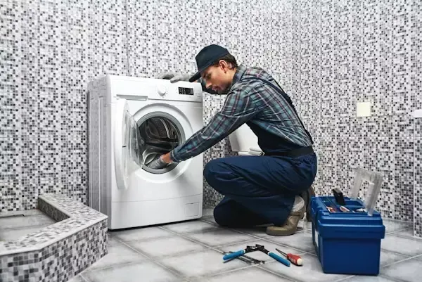 Washing machine repair technician fixing a washer in Philadelphia PA