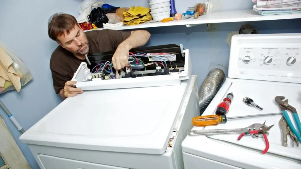 Dryer taking too long to dry repair technician inspecting a dryer in Philadelphia PA