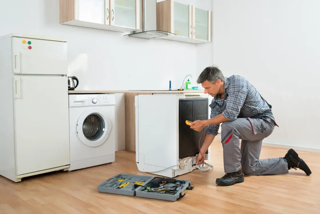 Kitchen appliance repair technician fixing an appliance in Philadelphia PA