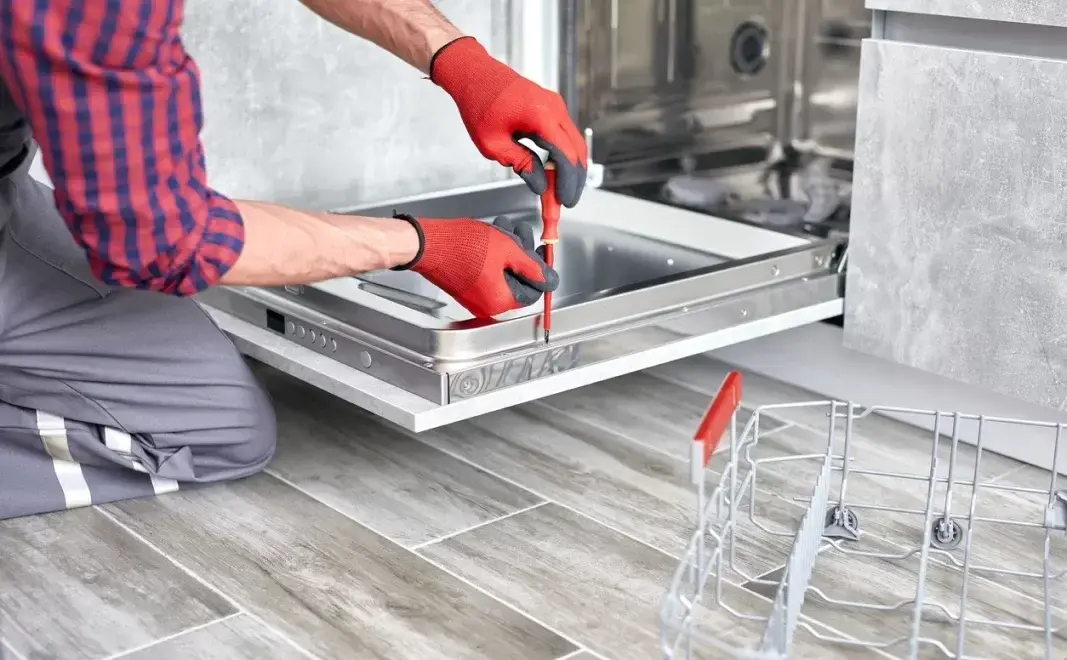 Professional dishwasher repair technician checking a dishwasher in Philadelphia PA