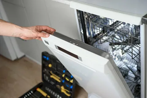 Residential dishwasher repair technician checking a dishwasher in Philadelphia PA