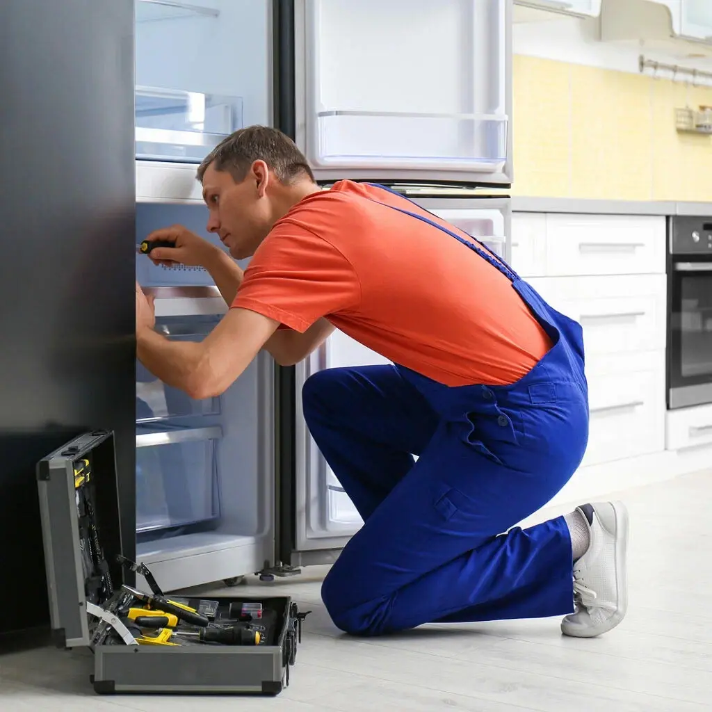Appliance repair technician working on a home appliance in Philadelphia PA