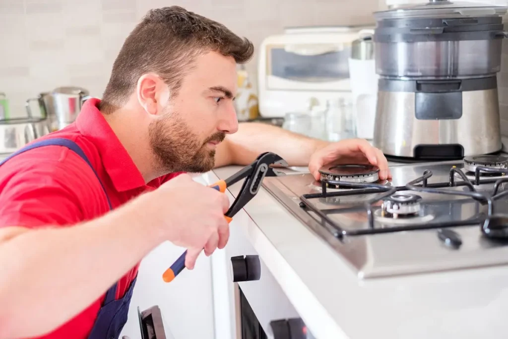 Emergency stove repair technician inspecting a stove in Philadelphia PA